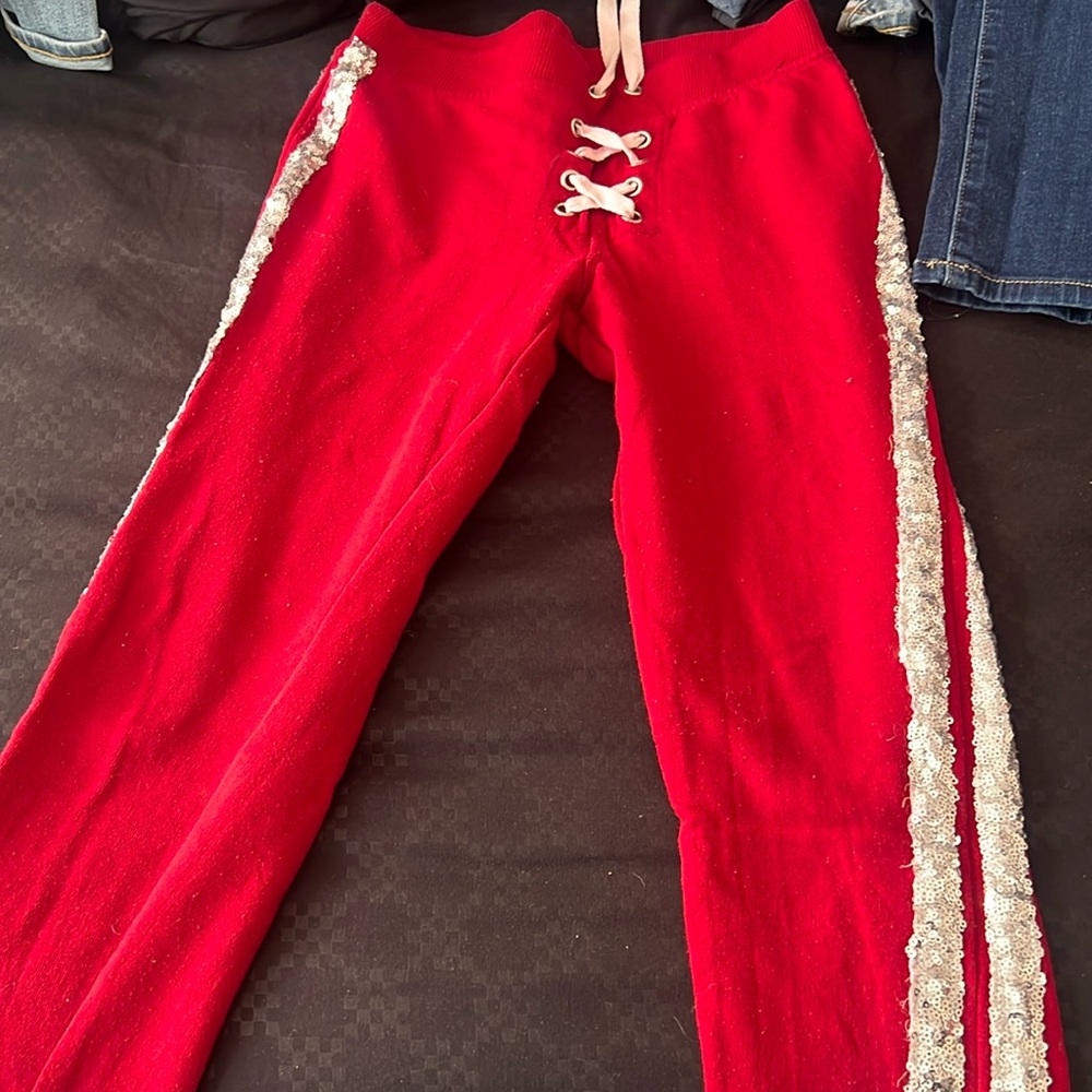 Red sweatpants with shiny side strips